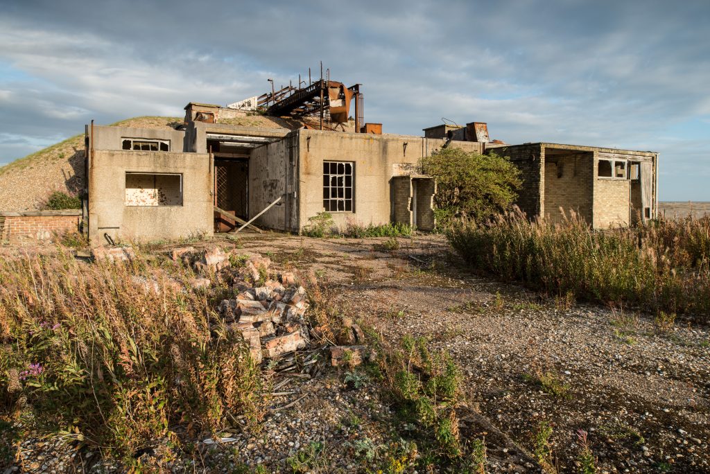 Derelict laboratory building with collapsed roof and nature reclamation, Orford Ness military site