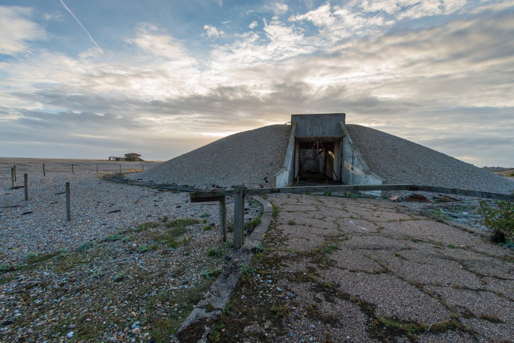 Earth-covered nuclear weapons testing bunker on shingle coast, Orford Ness, Suffolk