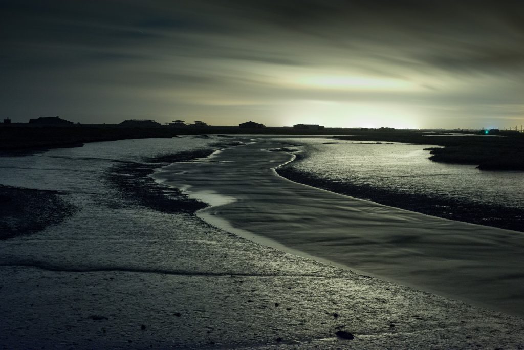 Long exposure tidal channel at dusk with silhouetted Cold War structures, Orford Ness, Suffolk